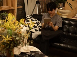 Young man drawing while seated.