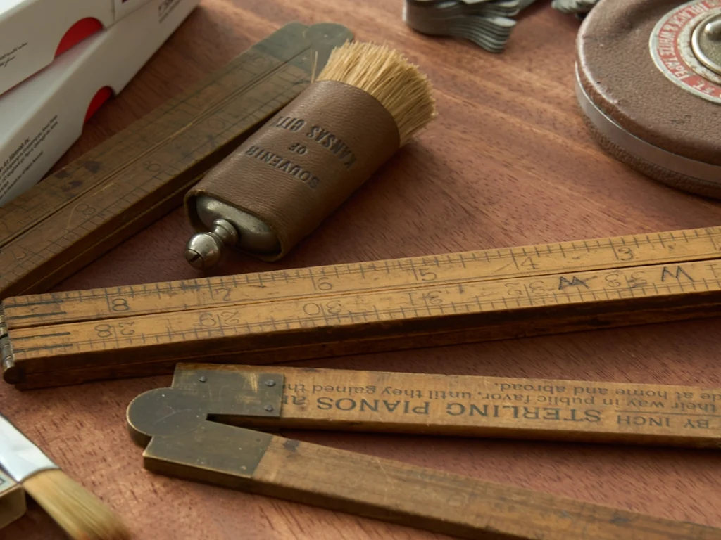 Antique wooden rulers and a brush used to sweep away eraser debris