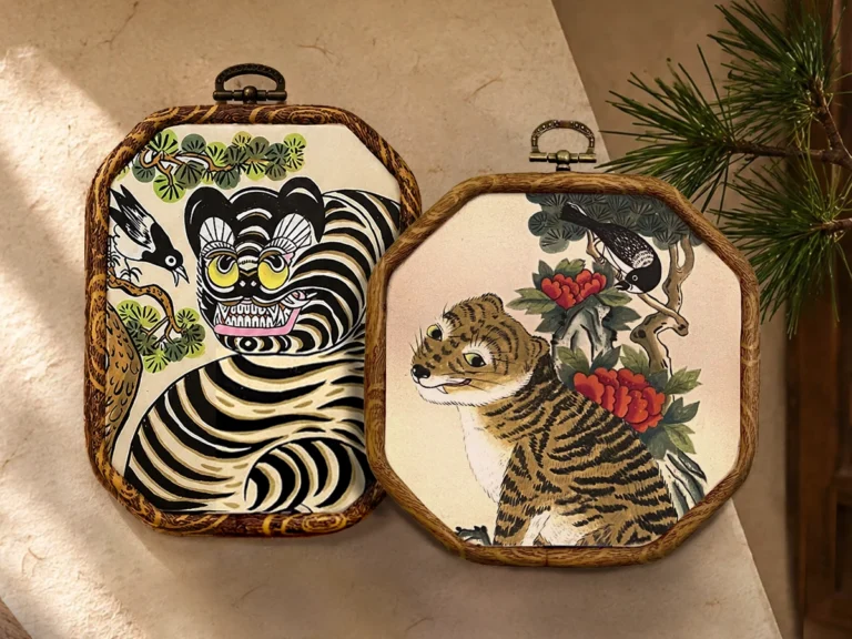 Two finished Minhwa tiger paintings displayed in wooden frames